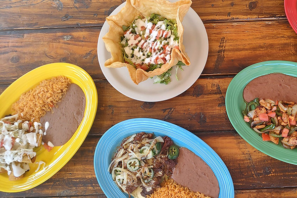 Colorful Mexican dishes on wooden table